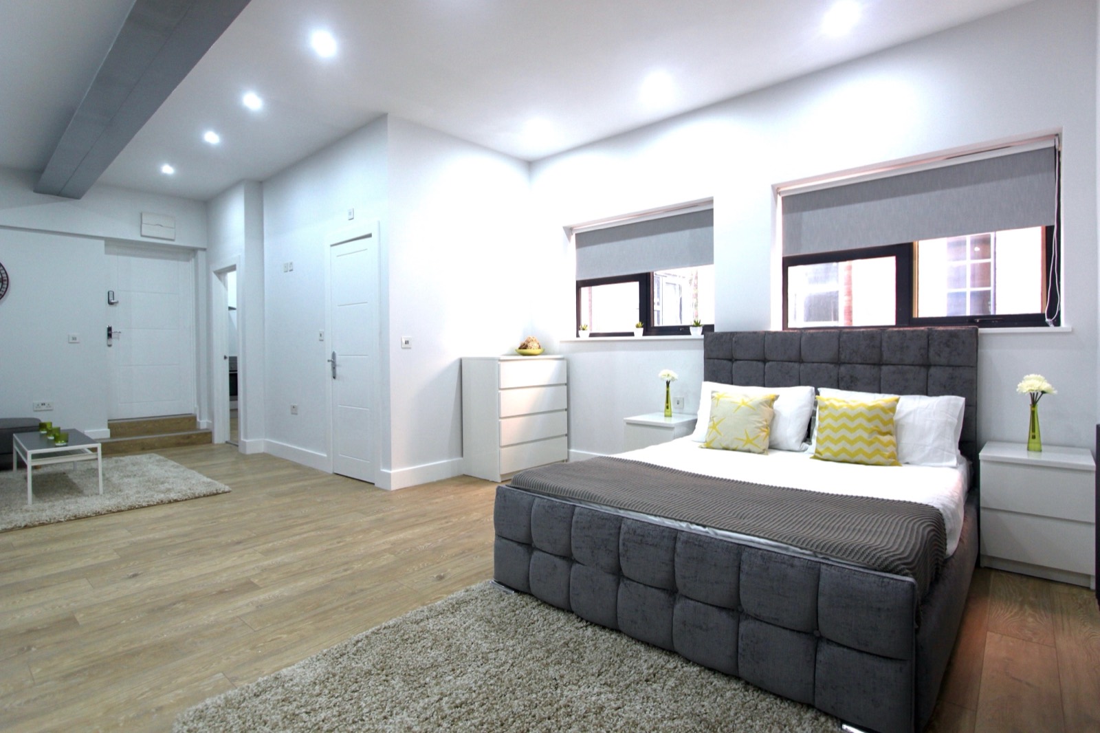 Double bedroom with exposed brick wall and large window
