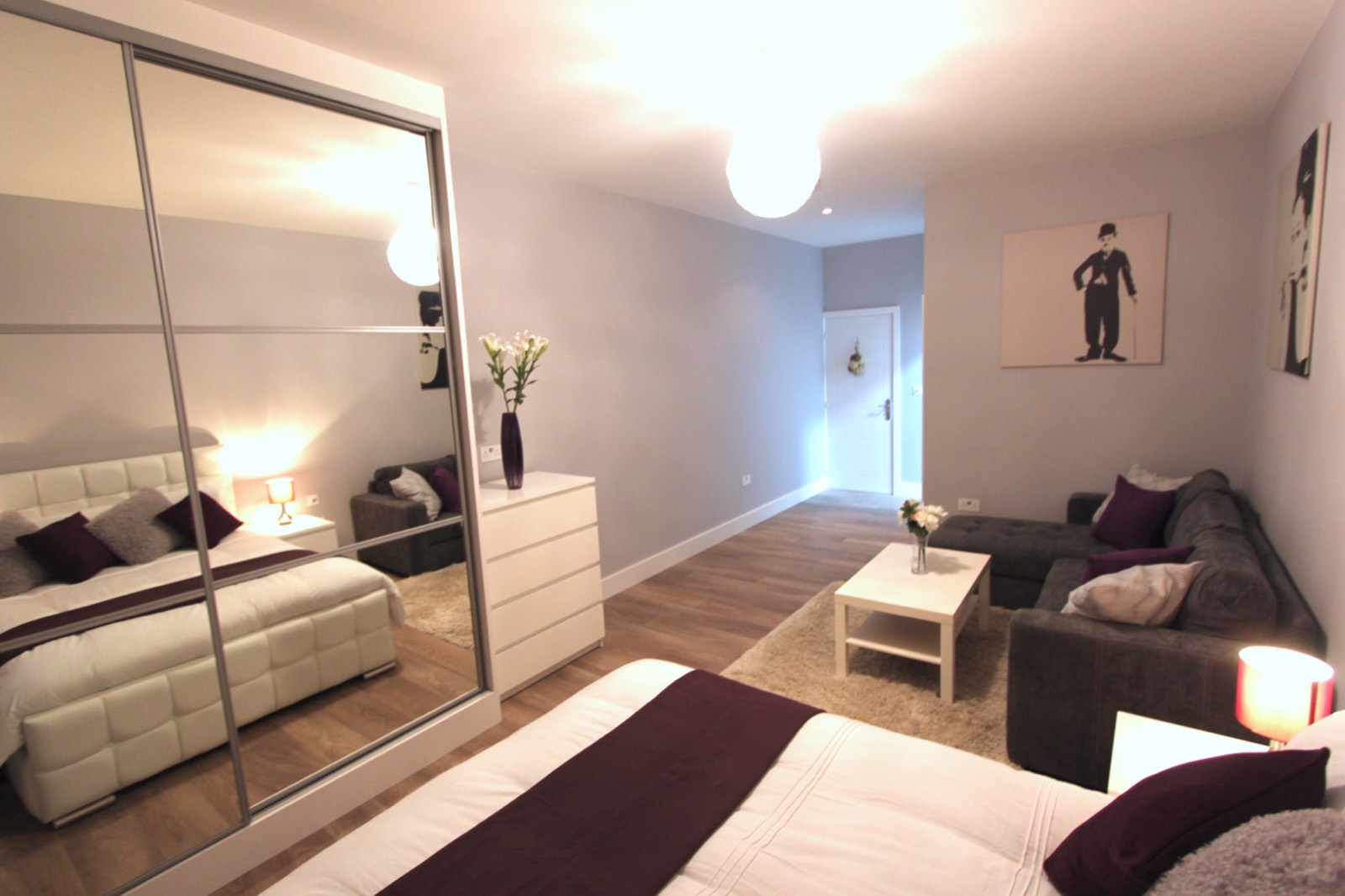 Double bedroom with mirrored wardrobes and feature wall