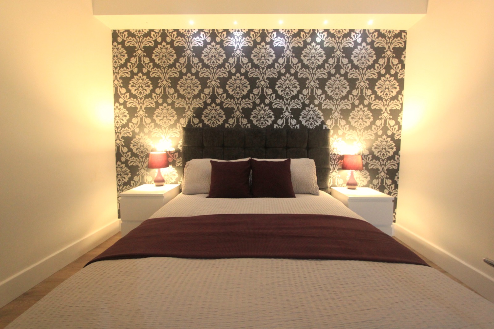 Double bedroom with bedside lamps and fitted wardrobes