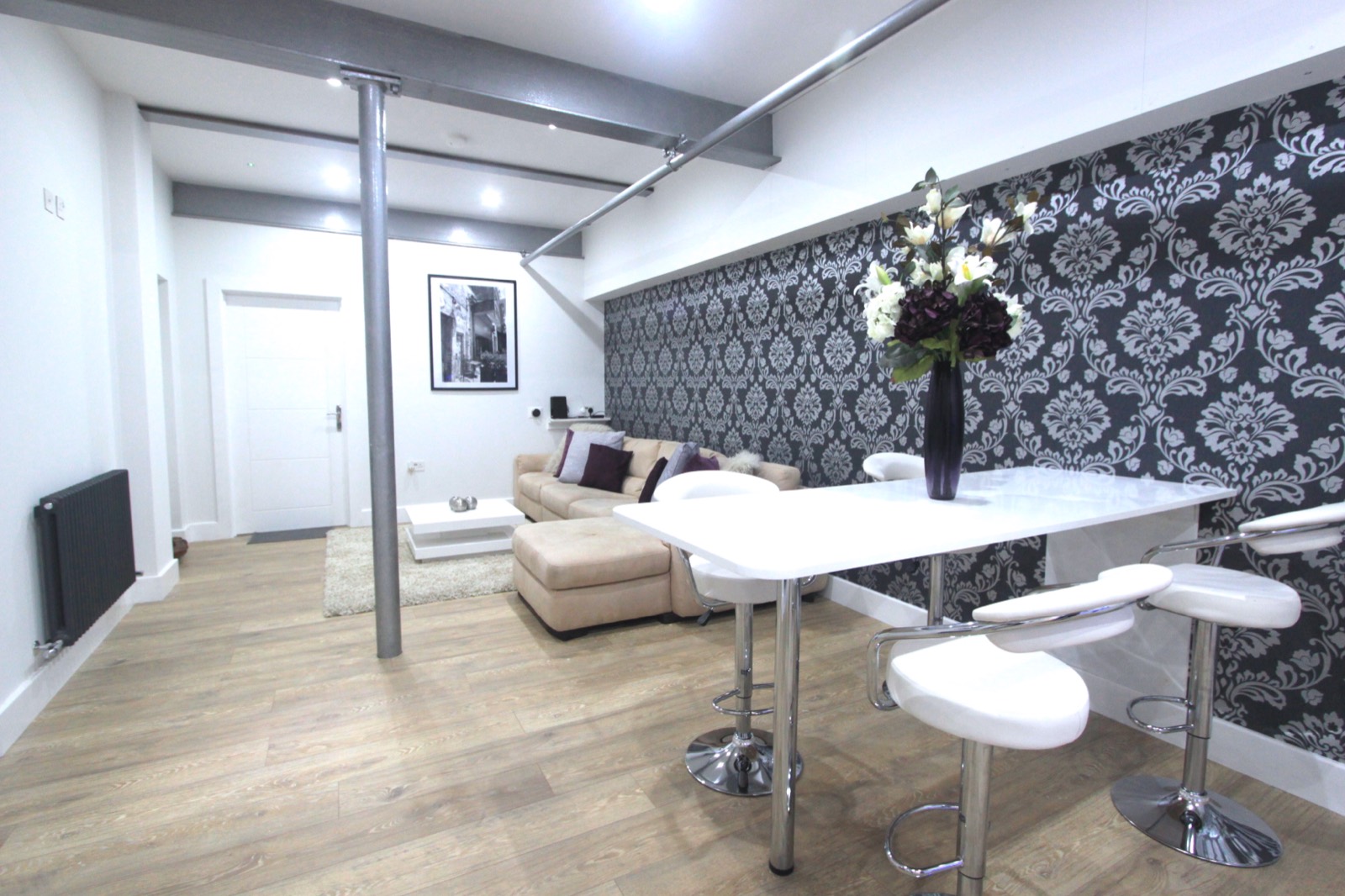 Shared dining area with white table and chairs