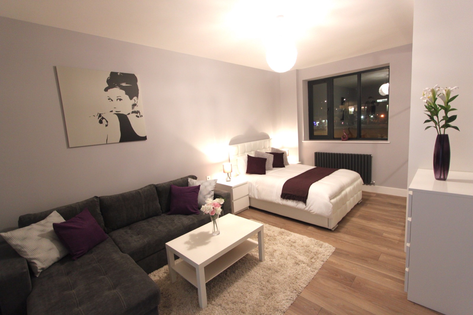 Open-plan studio with sofa and double bed